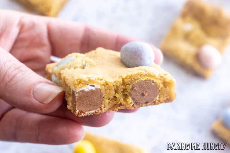 hand holding one of the mini egg cookie bars