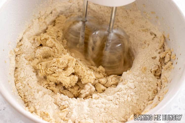 dough being mixed with electric mixer