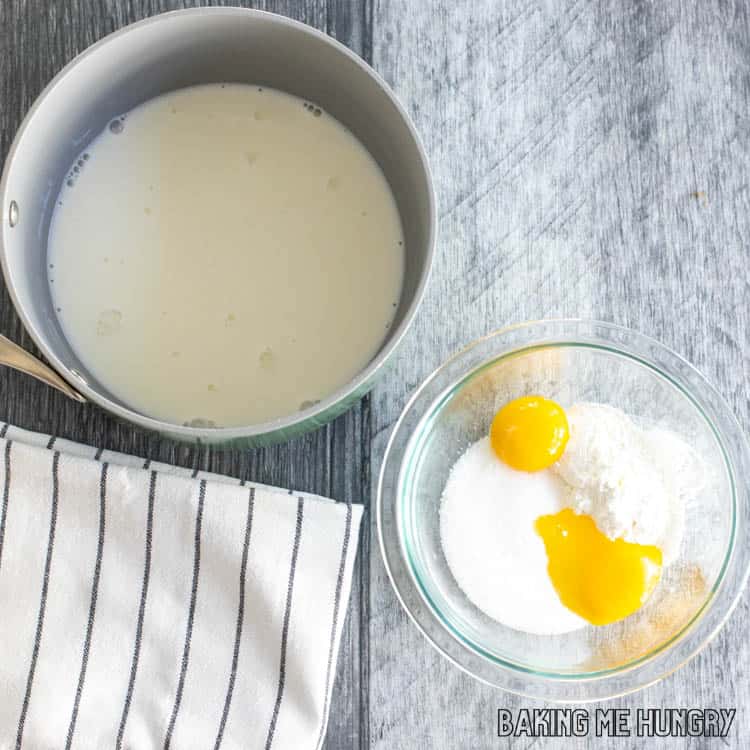 milk in saucepan with bowl of ingredients