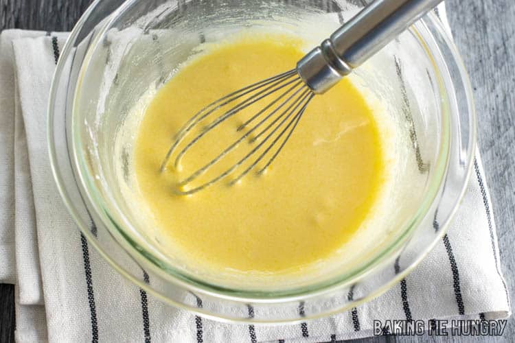 whisk in yellow liquid