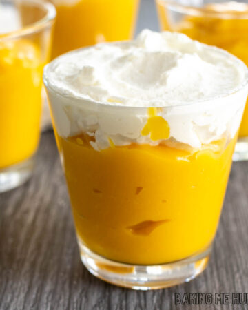 small cup of mango pudding without gelatin topped with whipped cream