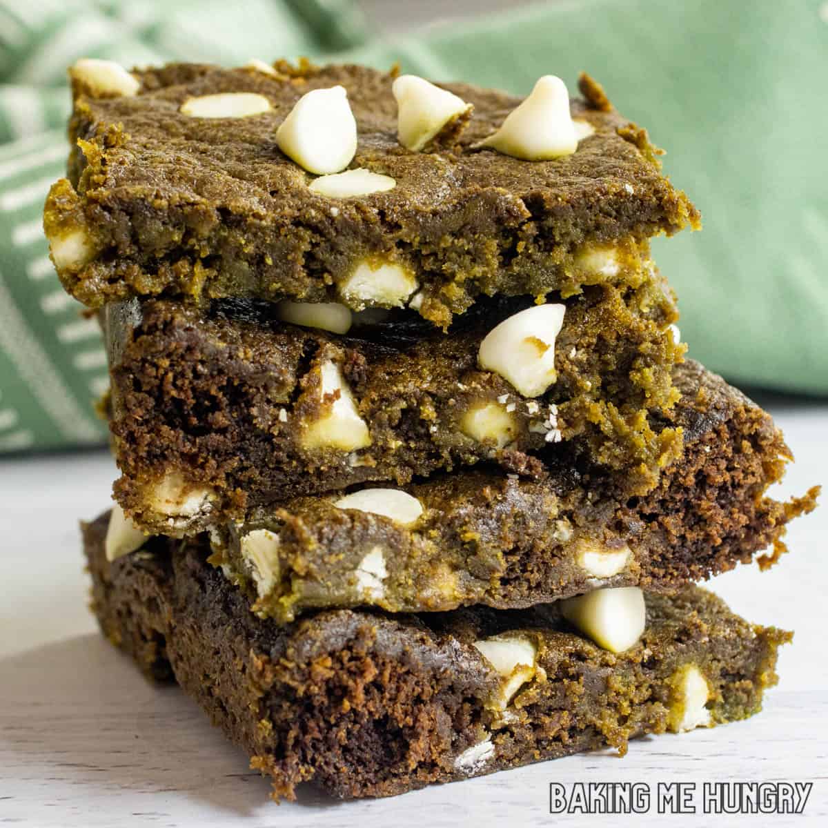 matcha blondies recipe in a stack close up to highlight the green color and white chocolate chips