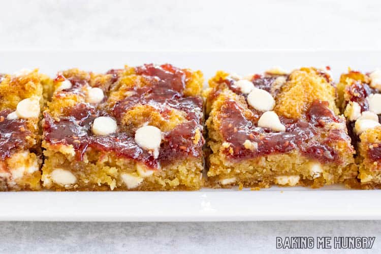 side view of a rectangular plate with four of the White Chocolate and Raspberry Blondies