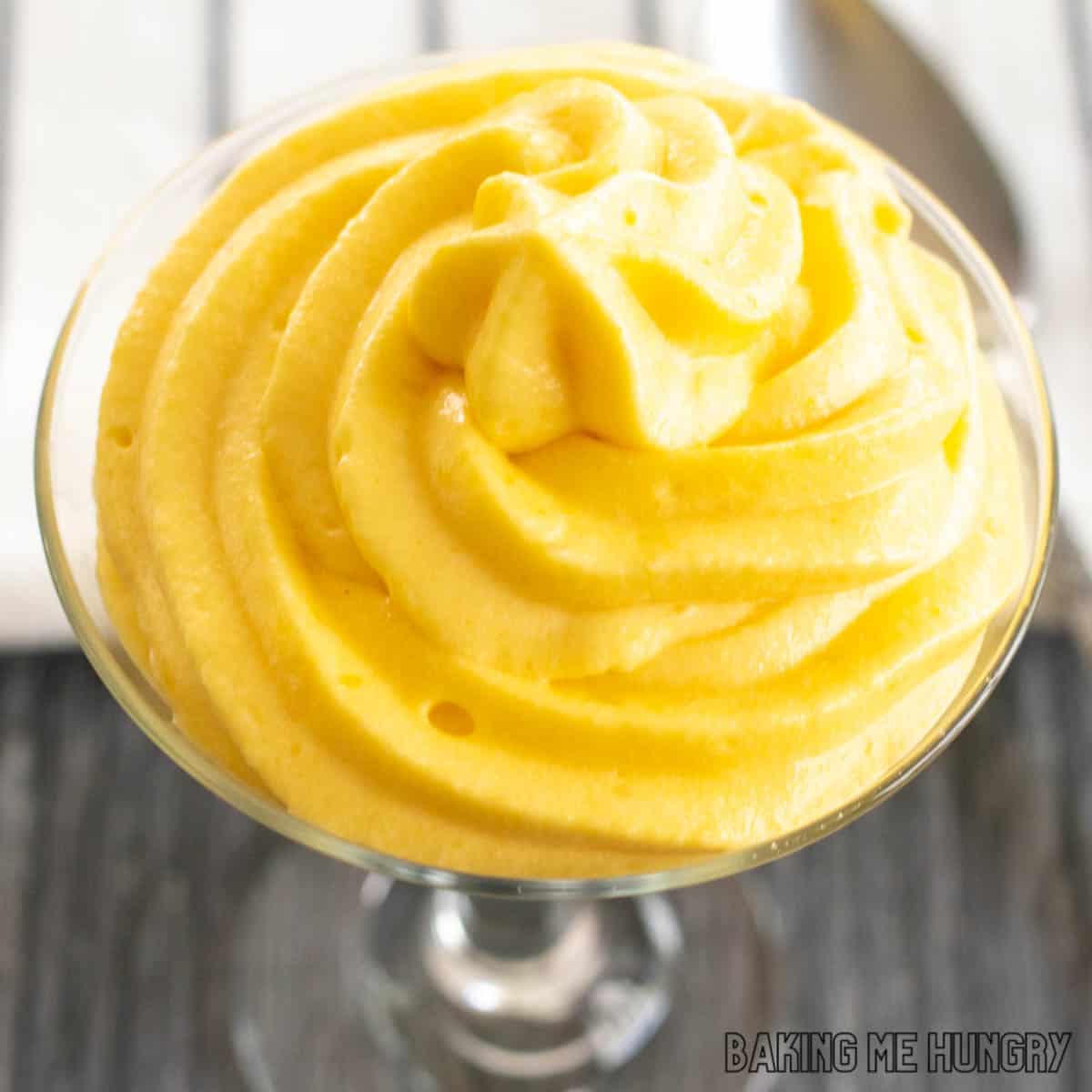 close up of mango mousse piped into a small glass