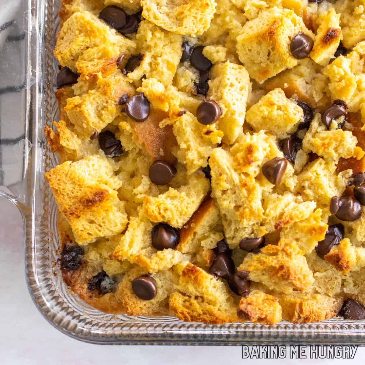 baked chocolate chip bread pudding in glass dish