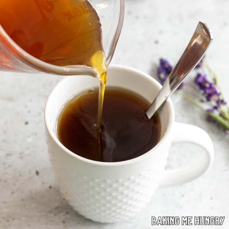 honey lavender syrup being poured into tea
