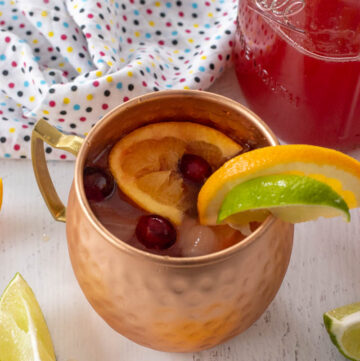 virgin moscow mule garnished with orange lime and cranberry