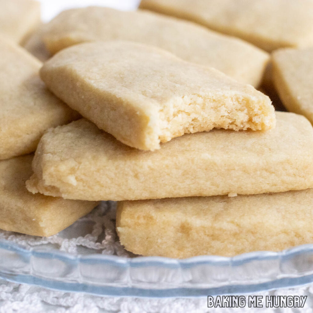 one of the 3 Ingredient Brown Sugar Cookies missing a bite on top of a stack of cookies