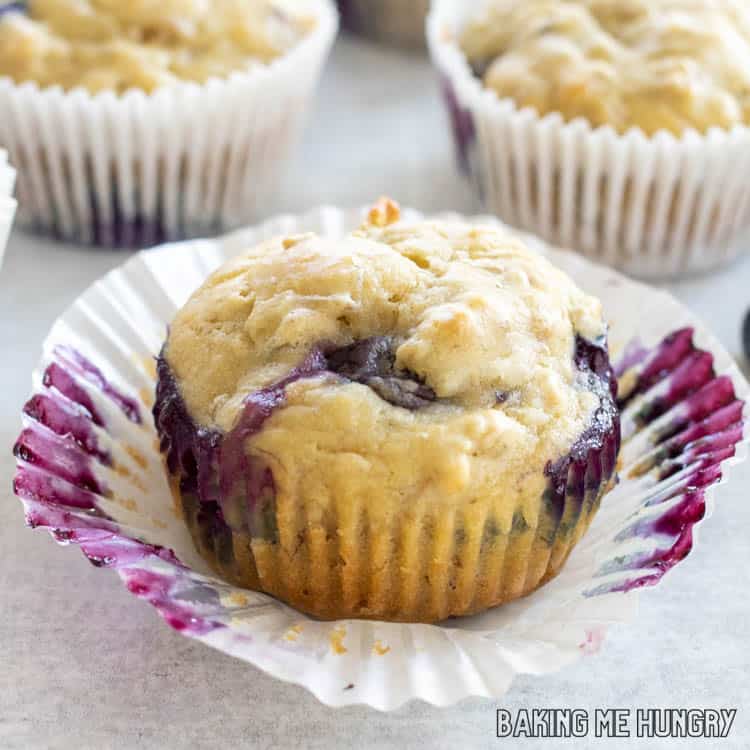 one of the muffins sitting on paper liner close up