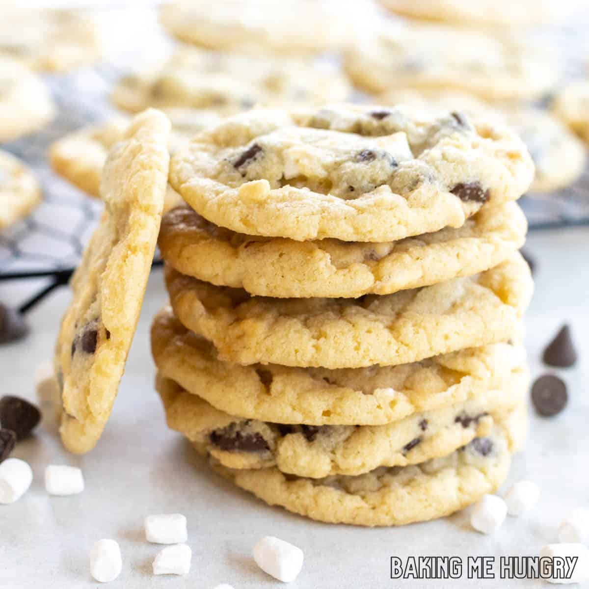 side view of chocolate chip marshmallow cookies in a stack with one leaning