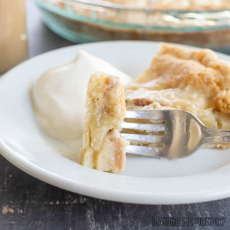 slice of pear pie on plate with whipped cream