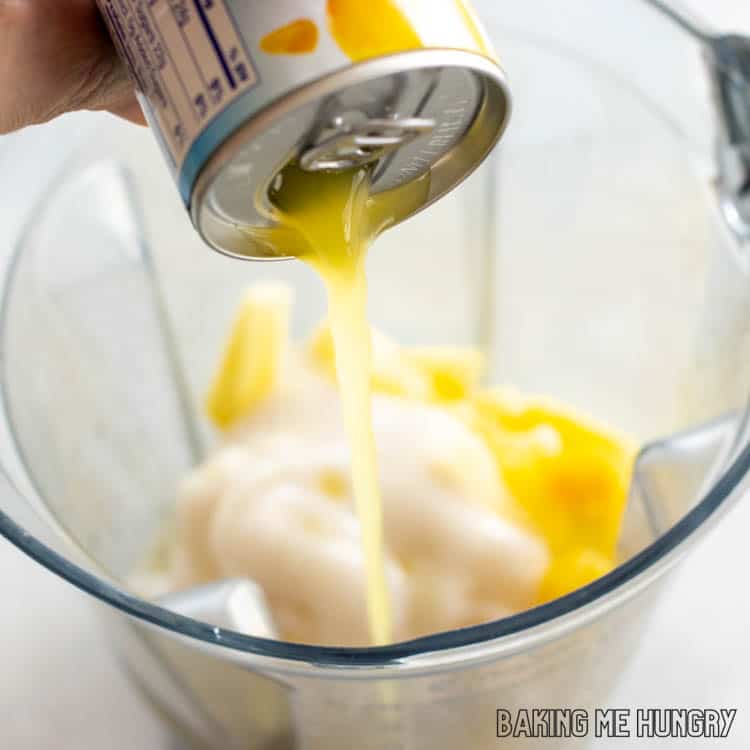 pineapple juice being poured into blender