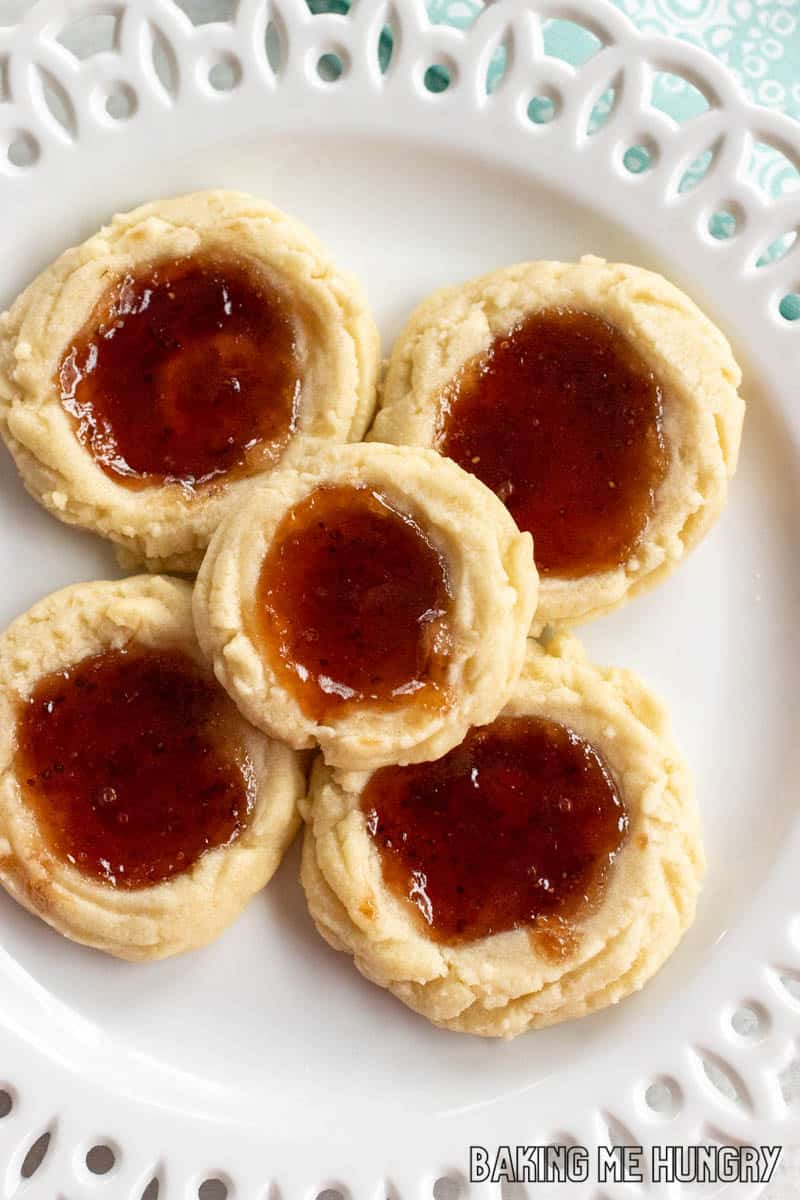 white plate with decorative edge with strawberry shortbread cookies