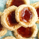 strawberry jam shortbread cookies sitting on light blue napkin from overhead