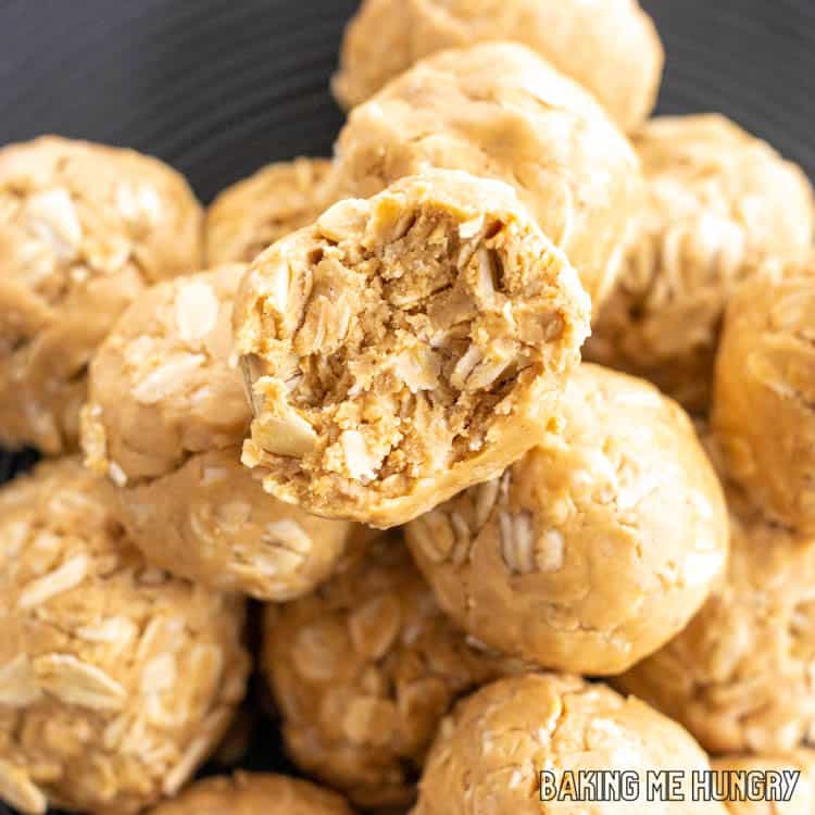 one of the 3 ingredient peanut butter oatmeal balls with a bite missing on top of pile