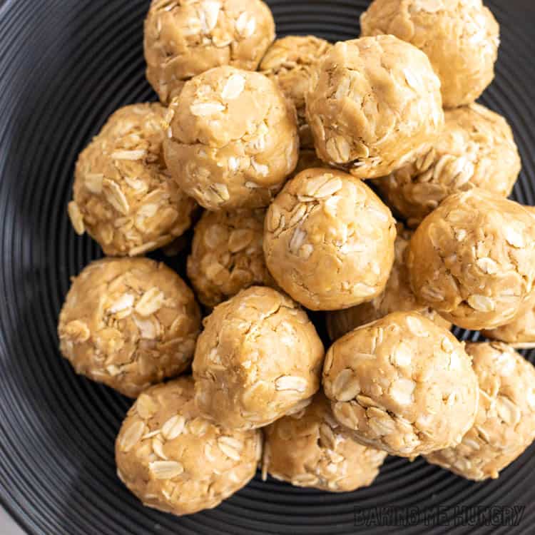 close up of 3 ingredient peanut butter oatmeal balls on black plate