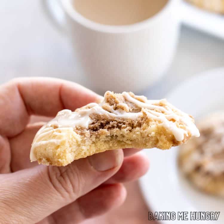 hand holding a coffee cake cookie with a bite missing