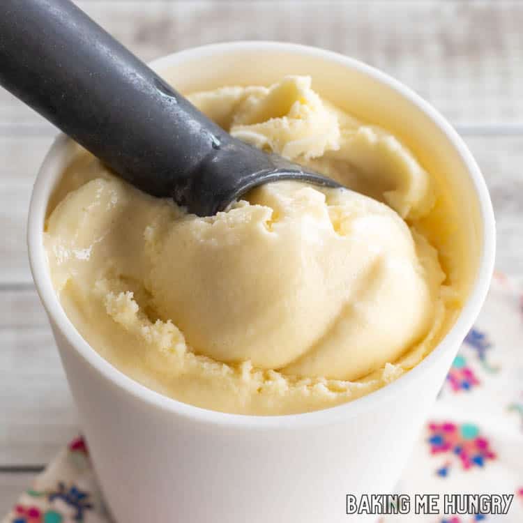 ice cream scoop in container of passion fruit ice cream