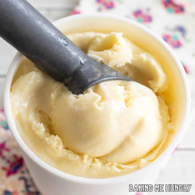 ice cream scoop in container of passion fruit ice cream