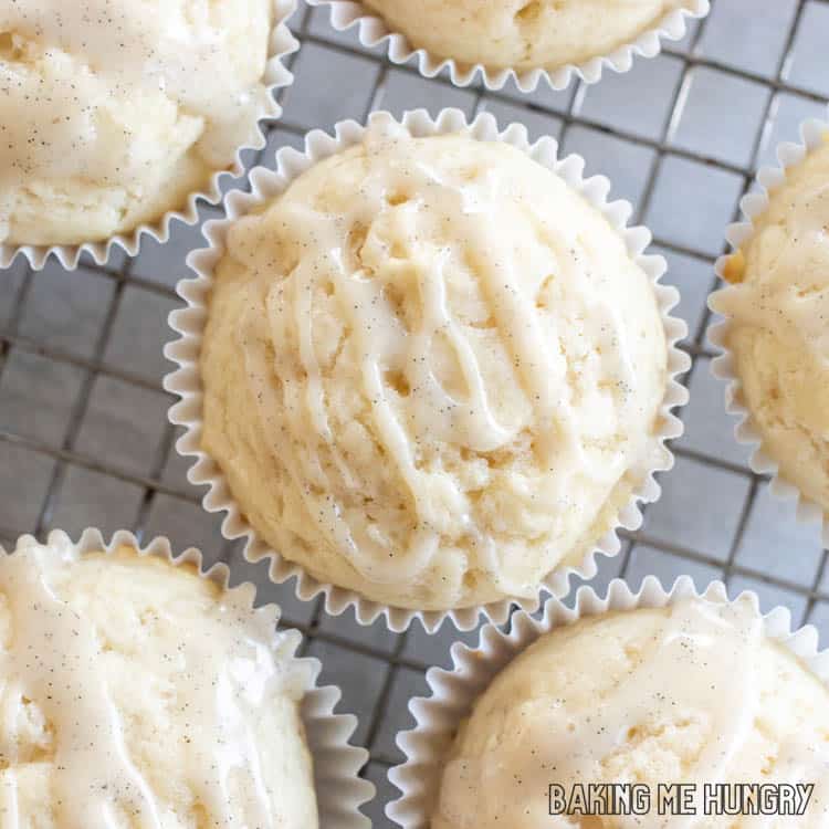 close up of glazed muffins from the vanilla muffins recipe on a cooling rack