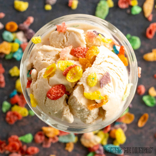 fruity pebbles ice cream topped with cereal in a bowl from overhead