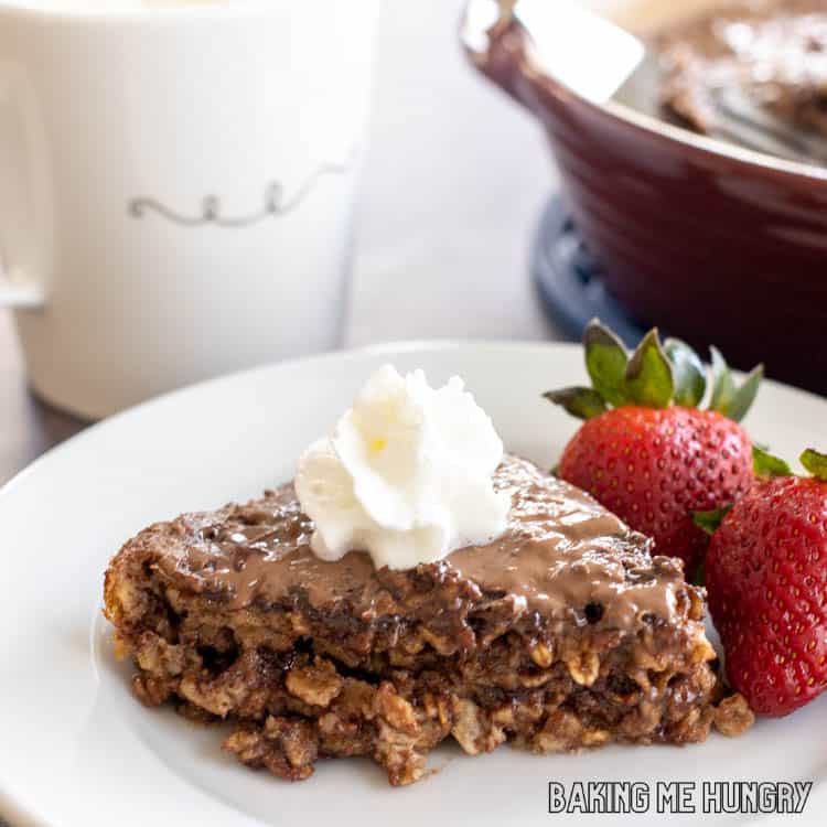 whipped cream topped nutella baked oatmeal on a plate