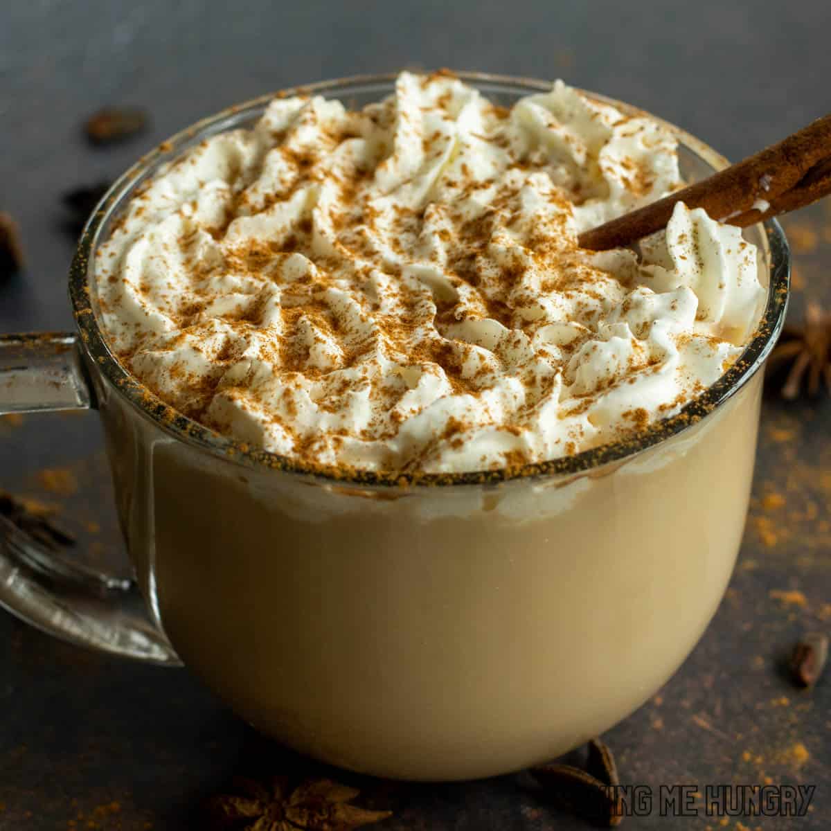 mug with the vanilla chai latte recipe topped with whipped cream and cinnamon