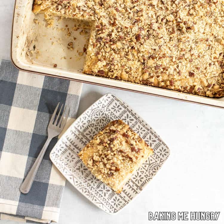 piece of cowboy coffee cake on plate with pan behind