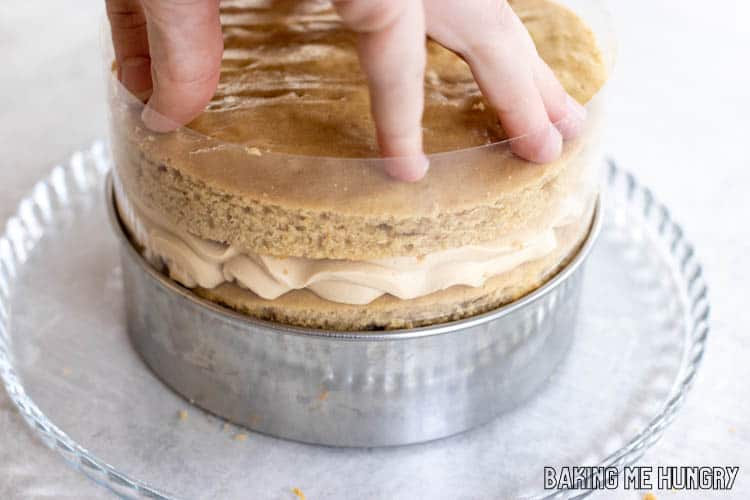 hand adding layer of cake