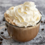 hot chocolate coffee recipe in glass mug topped with whipped cream
