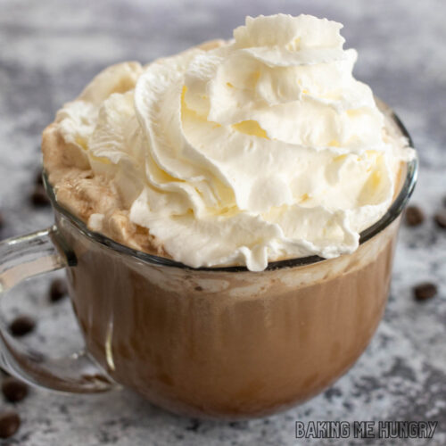 hot chocolate coffee recipe in glass mug topped with whipped cream