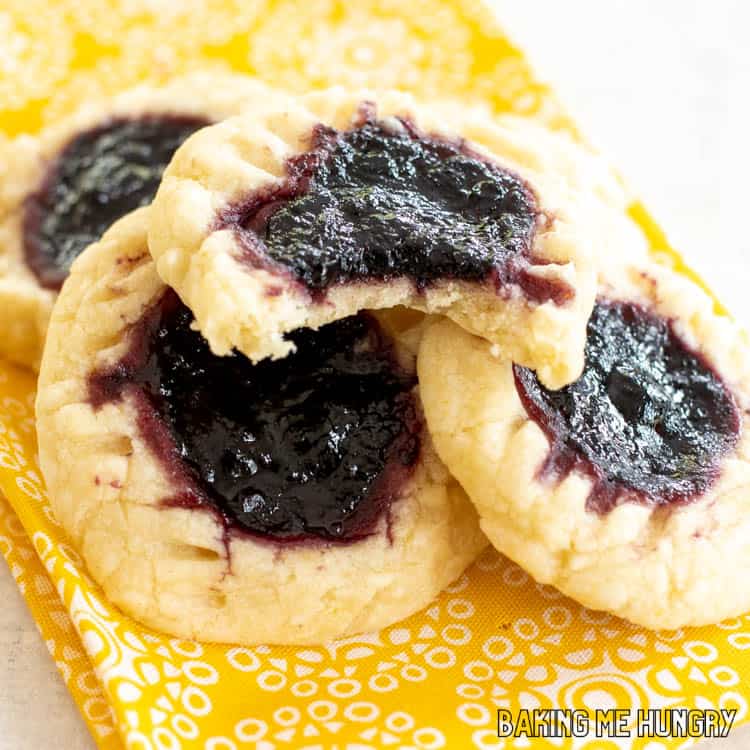 lemon blueberry cookies close up  in a pile with one missing a bite