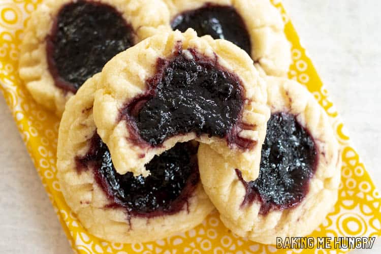 lemon blueberry cookies in a pile with one missing a bite