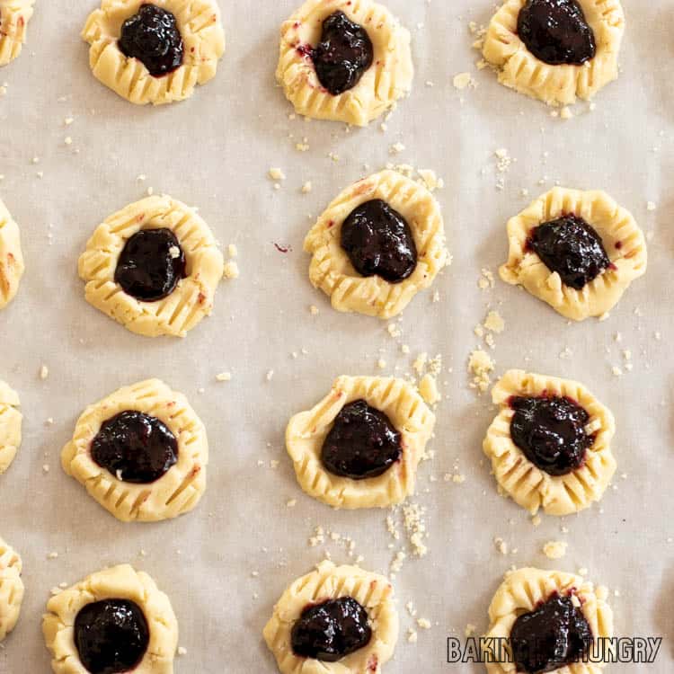dough formed into thumbprints and filled with jam