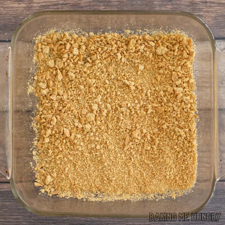 graham crackers crumbs in bottom of 8x8 glass dish