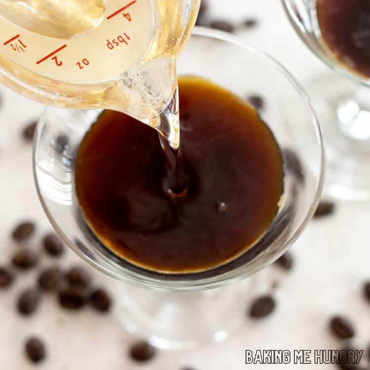 simple syrup being poured into martini glass