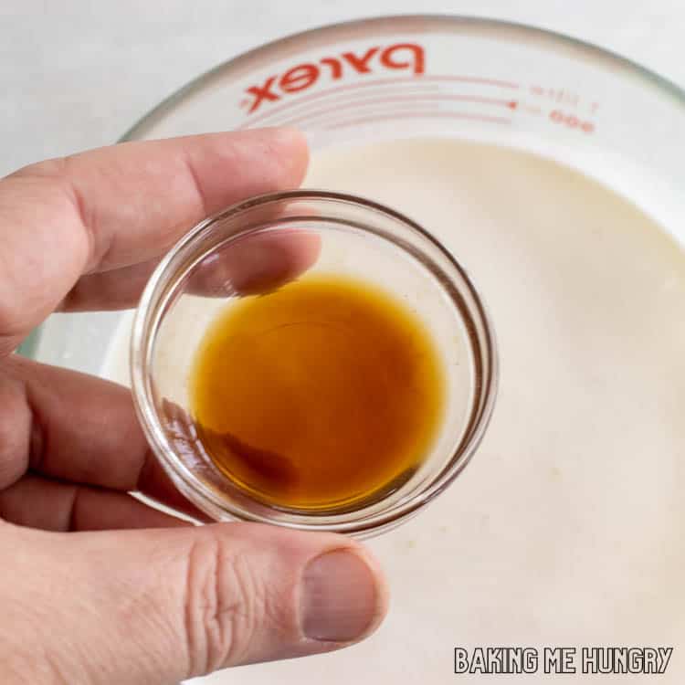 hand holding tiny bowl of extract