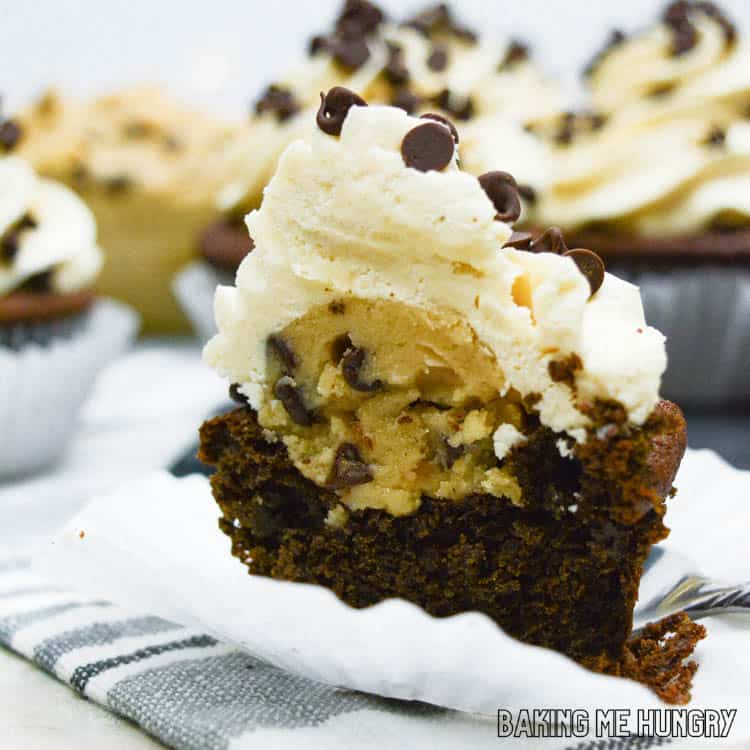 one of the cookie dough cupcakes cut in half to show filling