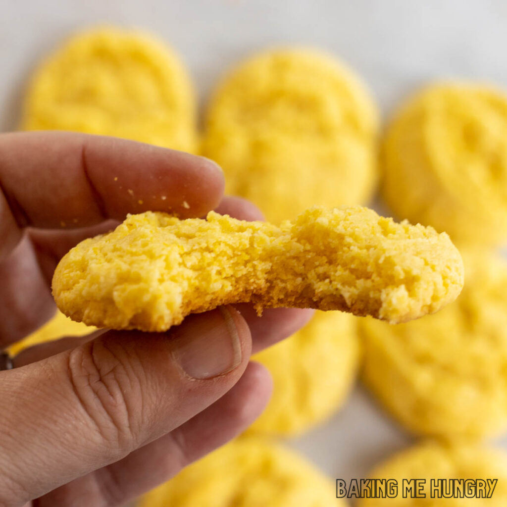hand holding one of the cornbread cookies recipe with a bite missing