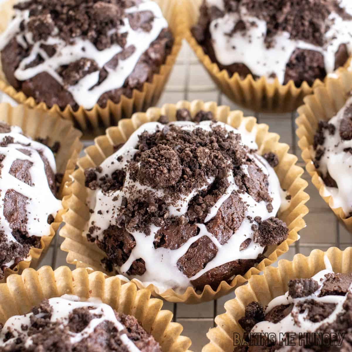 oreo muffins recipe shown close up with glaze and crushed cookies