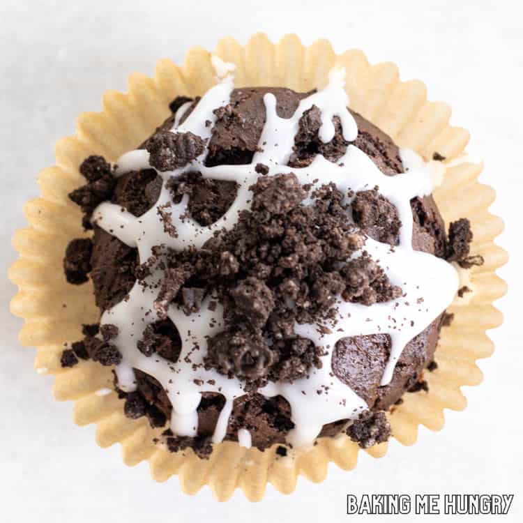 one of the oreo chocolate muffins sitting on its paper wrapper from overhead