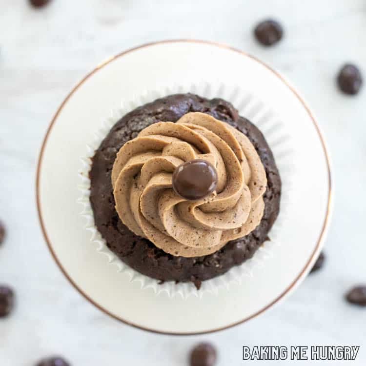 one of the espresso cupcakes topped with chocolate covered espresso bean on small cake stand