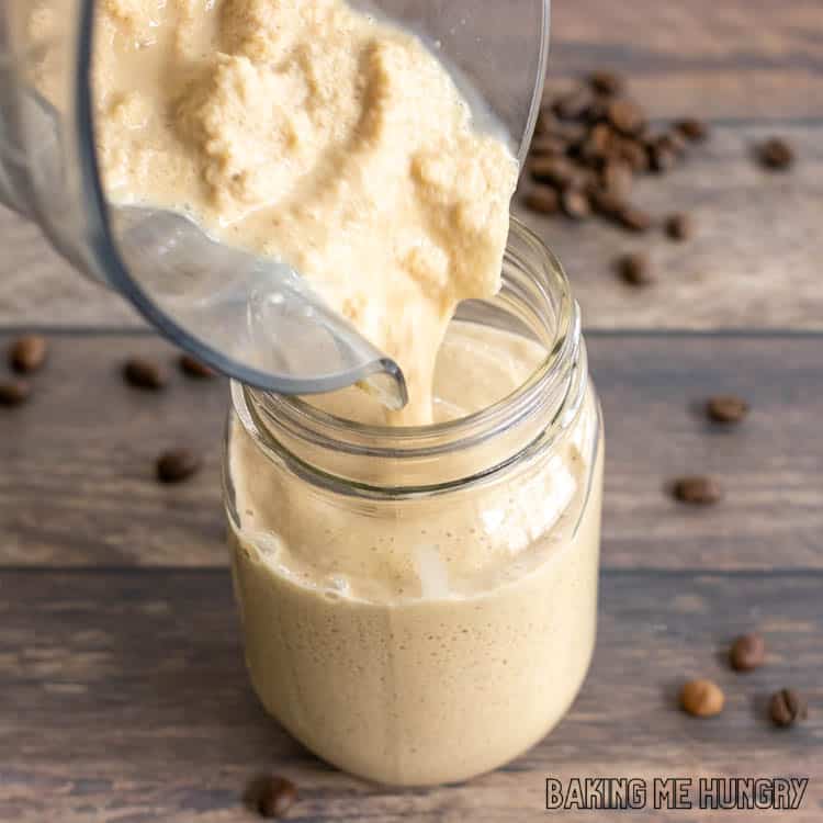 creamy mixture being poured from blender into mason jar