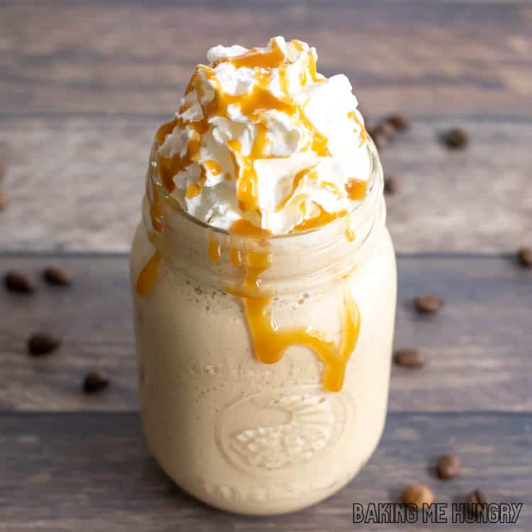 frosted coffee recipe in mason jar topped with whipped cream and drizzled with caramel