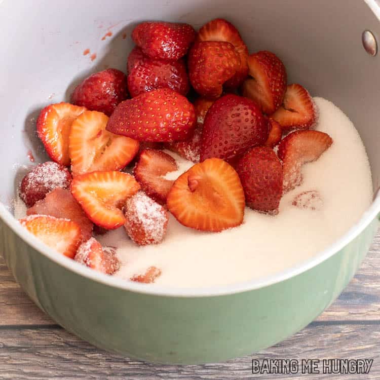 strawberries and sugar in saucepan
