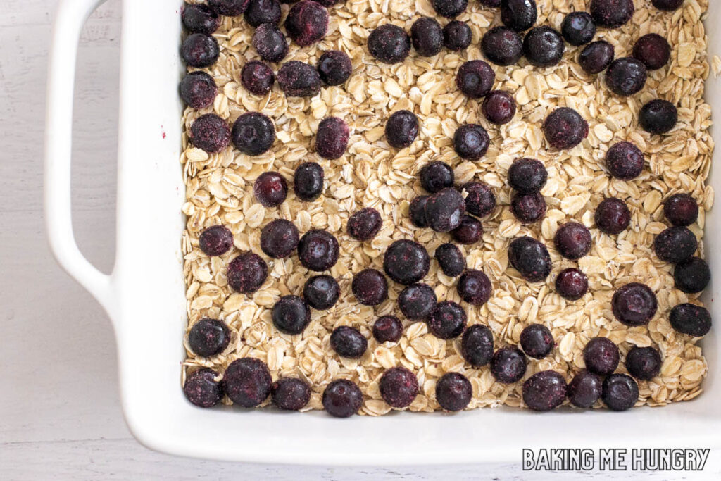 blueberries on top of oats in pan