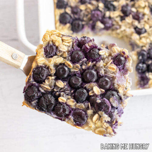 blueberry lemon baked oatmeal recipe being lifted by a serving spatula shown from drop down