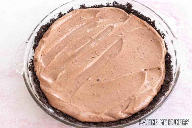 creamy chocolate mousse in oreo cookie crust in glass deep dish pie plate
