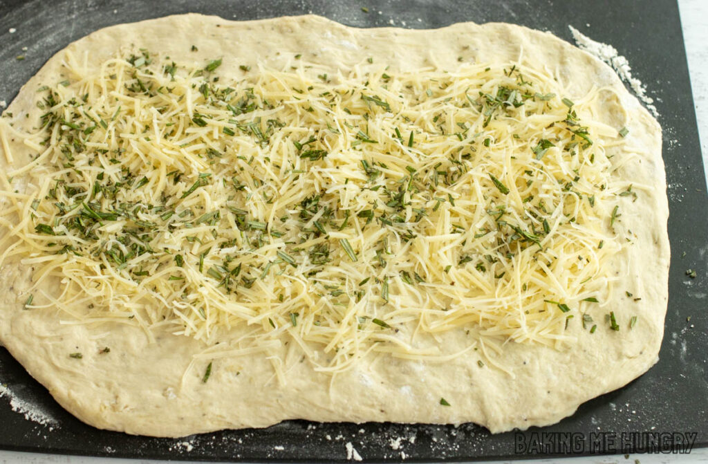 cheese and herb sprinkled on dough