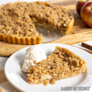 slice of apple crumb tart on a plate with ice cream